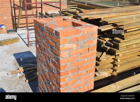building chimney  red bricks  unfinished house construction site
