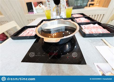 Shabu Or Hot Pot Served With Black And White Soup In Electric Pot Raw Sliced Beef In Black