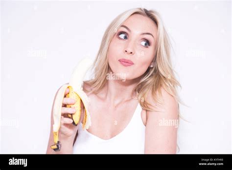 Pretty Blonde Woman Eating A Banana Stock Photo Alamy