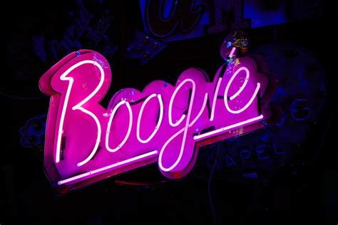 A Neon Sign With The Word Boogie Written On It S Side In Front Of A