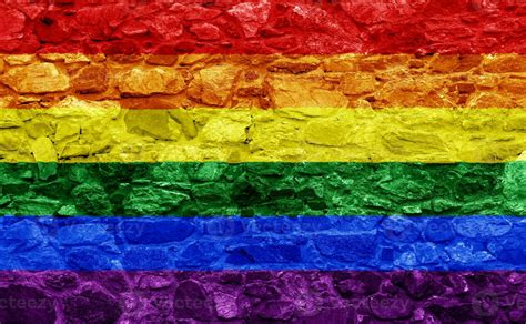 Flag Of The LGBT Community On The Background Of A Stone Wall Rainbow Symbol Of Gay Culture