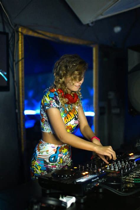 Beautiful Positive Girl DJ Blonde Energetic Plays And Listens To Music In A Nightclub Party At