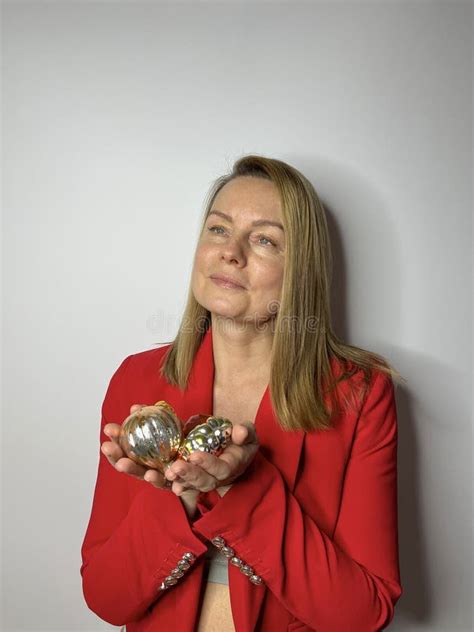 Mature Woman In A Jacket With Christmas Toys In Her Hands Stock Image Image Of Portrait
