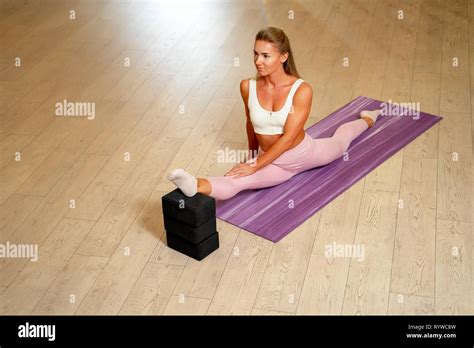 Blonde Sportswoman Doing Splits On Mat Stock Photo Alamy