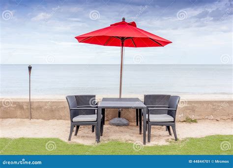 The Table Set Beach Chairs And Red Umbrella With Beautiful Beac Stock