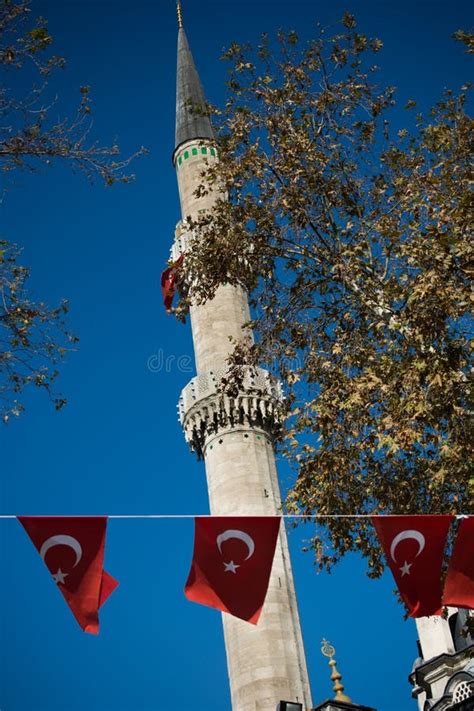 Turkish National Flag Hang On A Rope In The Street With A Minaret