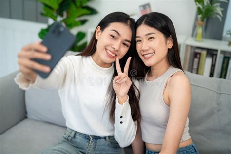 Asian Couple Taking Selfie Together In Living Room At Home Lesbian Couple Love Moments