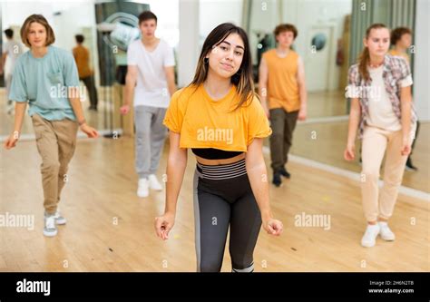 Happy Brunette Teenage Girl Practicing Vigorous Dance With Group Stock Photo Alamy