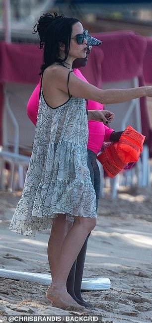 Andrea Corr Shows Off Her Toned Torso In A Tiny Black Triangle Bikini As She Jets Off To