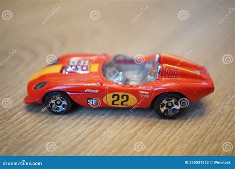 High Angle Shot Of A Mattel Hot Wheels Toy Model Glory Chaser Red Race Car On A Wooden Surface