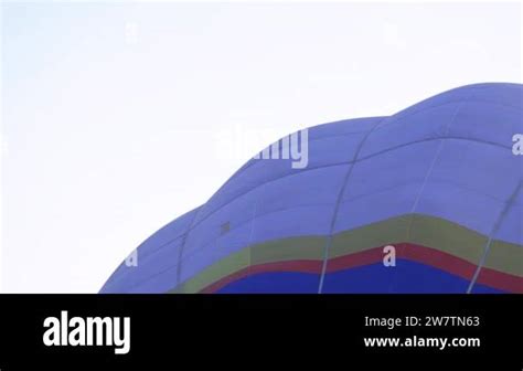 A Man Lifts Up A Huge Balloon At A Balloon Festival Blowing Up Hot Air Balloons Flame Rising