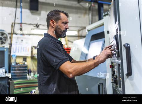 Side View Of A Mature Caucasian Man Working In The Control Station Of A