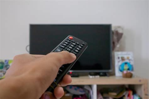 Premium Photo Male Hand Holding Tv Remote Control Directed On The