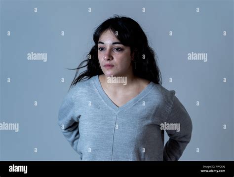 Close Up Portrait Of Beautiful Young Woman With Sad Eyes Looking