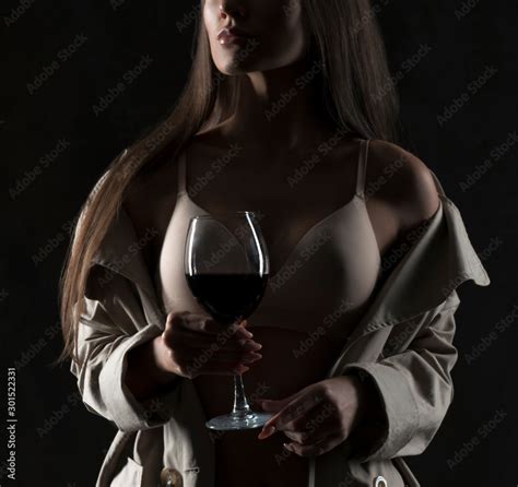 Partial Portrait Of Sensual Woman With Red Wine Glass In Hands Wearing Lingerie Stock Photo