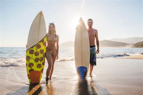 Couple De Surfeurs Avec Leurs Planches De Surf Photo Gratuite