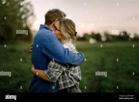 Mature Couple Hugging Each Other On Field During Sunset Stock Photo Alamy