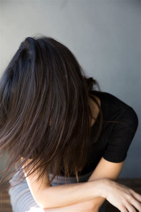 Pretty Brunette Woman Smiling And Laughing And Hiding Behind Her Hair By Stocksy Contributor