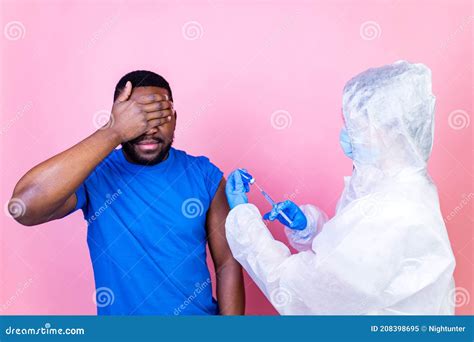 African American Man Scientist In Ppe Suite Uniform Showing Medicine