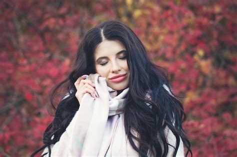 Premium Photo Autumn Brunette Woman Smiling On Red Leaves Background Outdoors