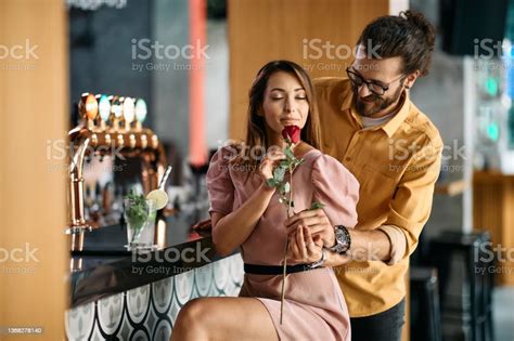 Romantic Man Surprising His Girlfriend With Red Rose On Valentines Day