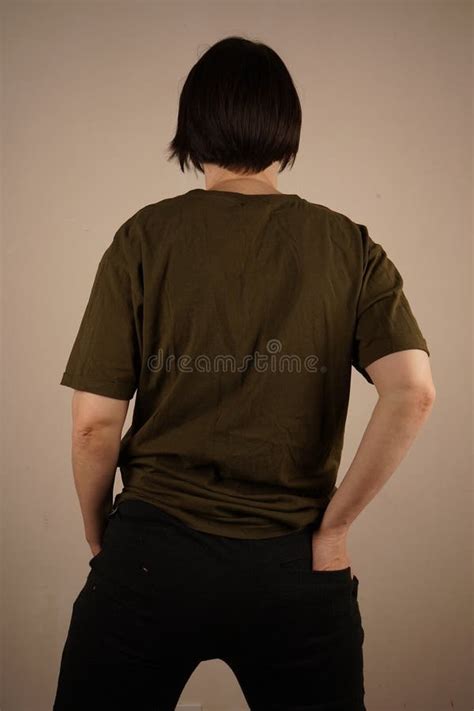 Portrait Of A Short Haired Brunette She Put Her Feet Shoulder Width Apart Put Her Hands In Her