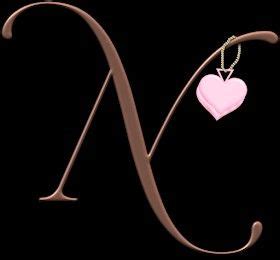 The Letter M With A Heart Hanging From It S Side On A Black Background