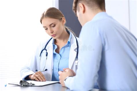 Doctor And Patient In Hospital Beautiful Blonde Physician Consulting Business Man About His