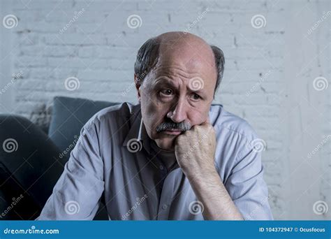 Portrait Of Senior Mature Old Man On His S At Home Couch Alone Feeling Sad And Worried