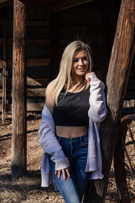 Lovely Blonde Model In Western Gear Poses Outdoor While Enjoying The Spring Weather Stock Image