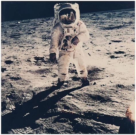 Buzz Aldrin Walking On The Surface Of The Moon Near A Leg Of The Lunar