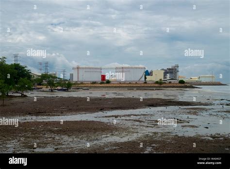 A Couple Of Oil Storage Tanks And Power Lines At The Malacca Strait