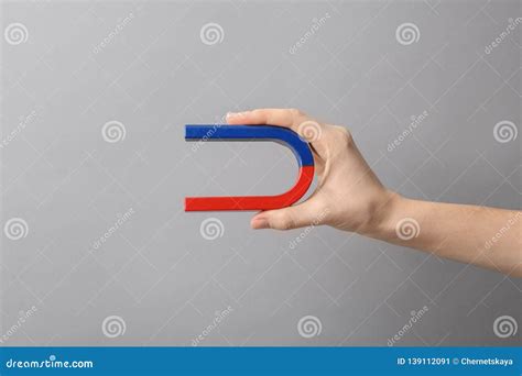 Woman Holding Magnet On Grey Background Closeup Stock Image Image