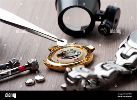 watch battery replacement, watchmaker replacing watch battery on quartz ...