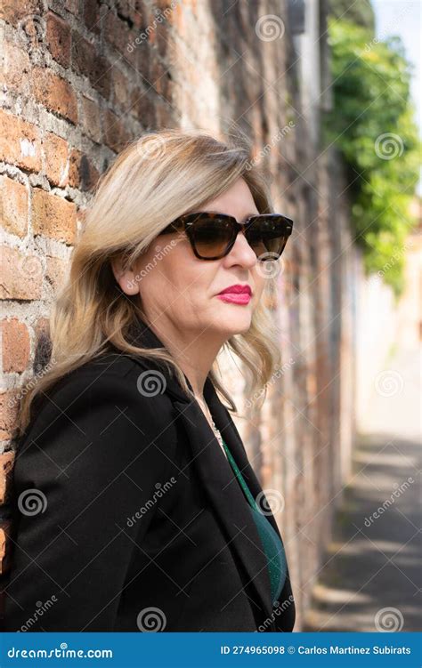 Mature Blonde Woman With Sunglasses Posing Stock Photo Image Of Blond Brick