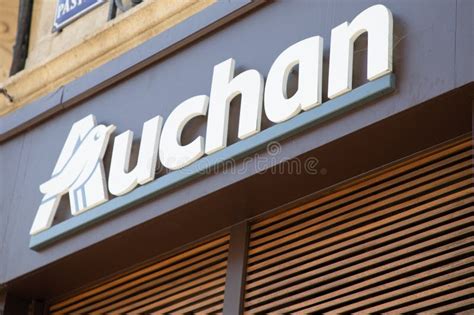 Auchan Logo Brand And Text Sign Brown City Entrance Wall Facade Of