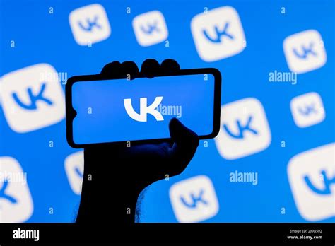 Smartphone with the VKontakte social network logo on the screen in a ...