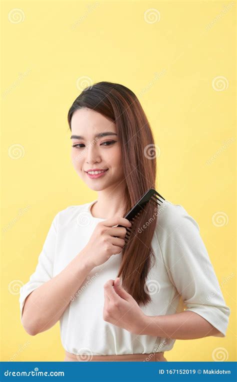 Happy Woman Brushing Her Beautiful Healthy Wavy Hair Stock Image