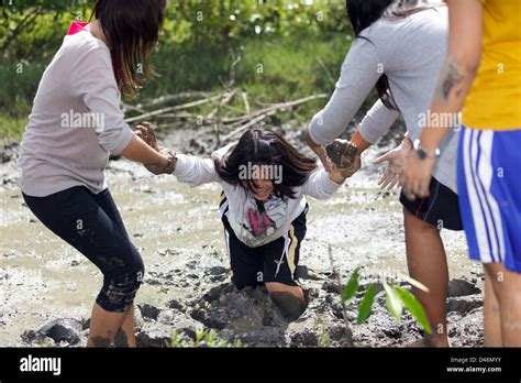 Rescuing Woman Sinking In Mud While Planting New Trees For Mangrove