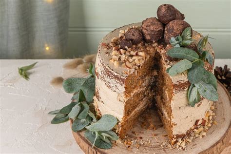 Slice Of Delicious Naked Chocolate And Hazelnuts Cake On Table Rustic Wood Kitchen Countertop