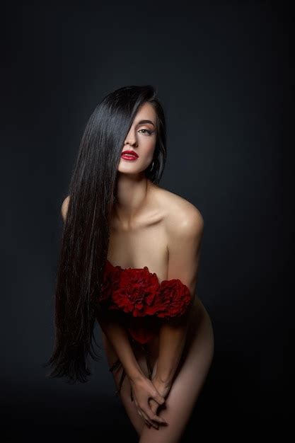 Premium Photo Beautiful Brunette Woman With A Bouquet Of Red Rose Flowers In Red Corset Long