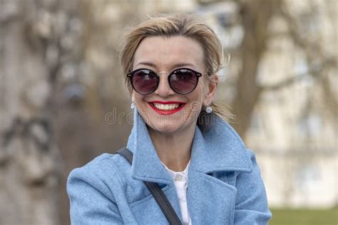 Portrait Of A Blonde Year Old Girl In A Pink Hat And Pink Dress On A Motley Background Stock