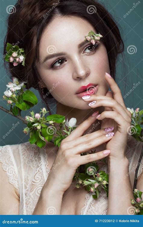 Beautiful Brunette Girl In Lingerie With A Gentle Romantic Make Up Pink Lips Holding Flowers