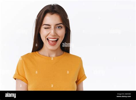 Sassy And Cheeky Good Looking Brunette Woman Winking Attractive Girl Standing Near Bar Smiling