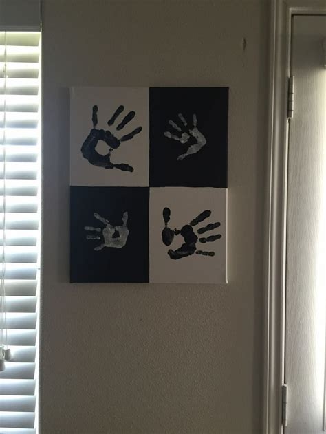 Three Hand Prints Hanging On The Wall Above A Toilet In Front Of A