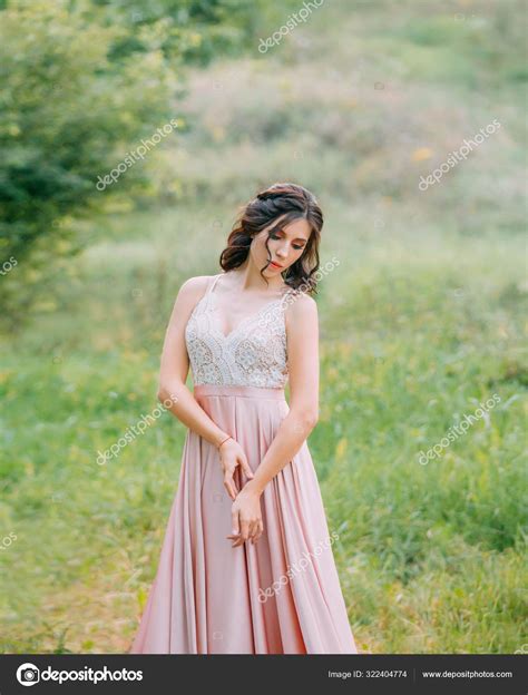 Cute Attractive Brunette Woman Enjoying Nature In Delicate Elegant Pink Silk Dress With White