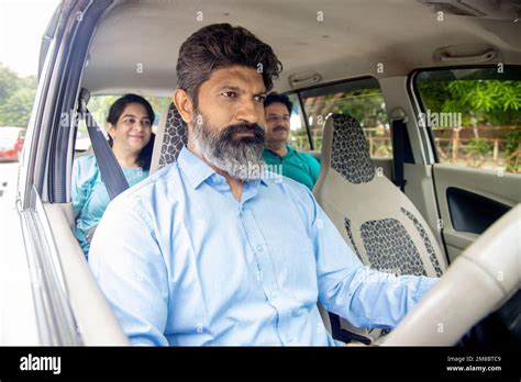 Mature Indian Man Taxi Driver Carrying Passenger Sitting In The Back Seat Man Driving Cab Stock