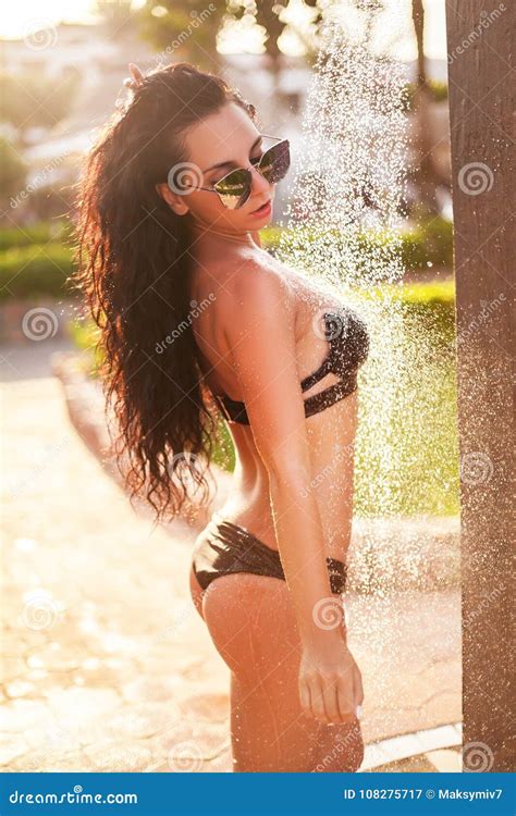 A Woman In A Bikini Standing Under An Outdoor Shower On A Beach Stock Image Image Of Showering