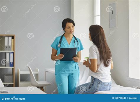 Doctor Or Nurse Advises Patient In Clinic Office Medical Service