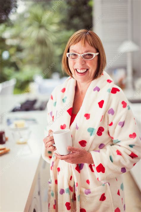 Mature Woman Drinking Coffee In Bathrobe Stock Image F016 7502